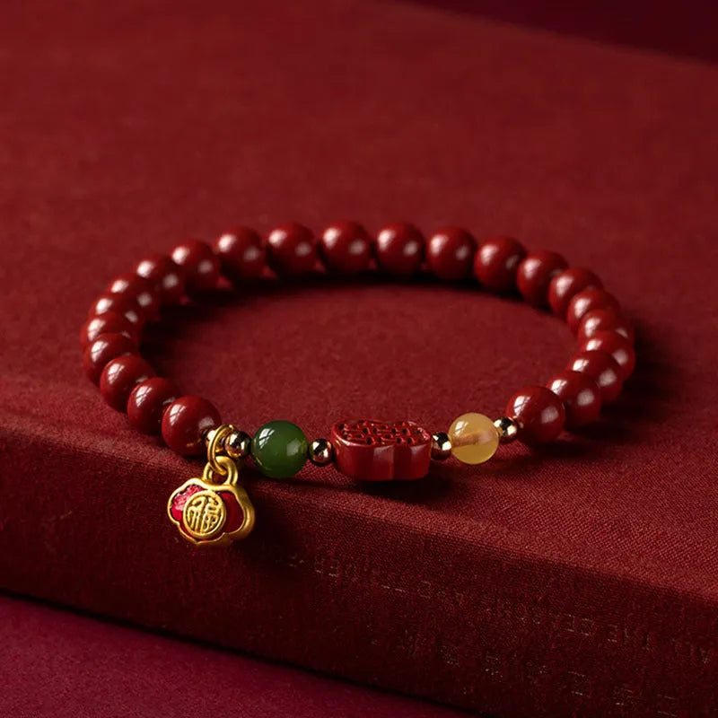 Emperor sandstone cinnabar bracelet with fu character and happy eyebrow design