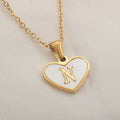 Gold plated heart-shaped necklace with a personalised initial letter and white shell detail on a 50cm adjustable chain.