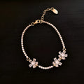 Gold-coloured women's bracelet with geometric quadrilateral design and zircon stone inlays