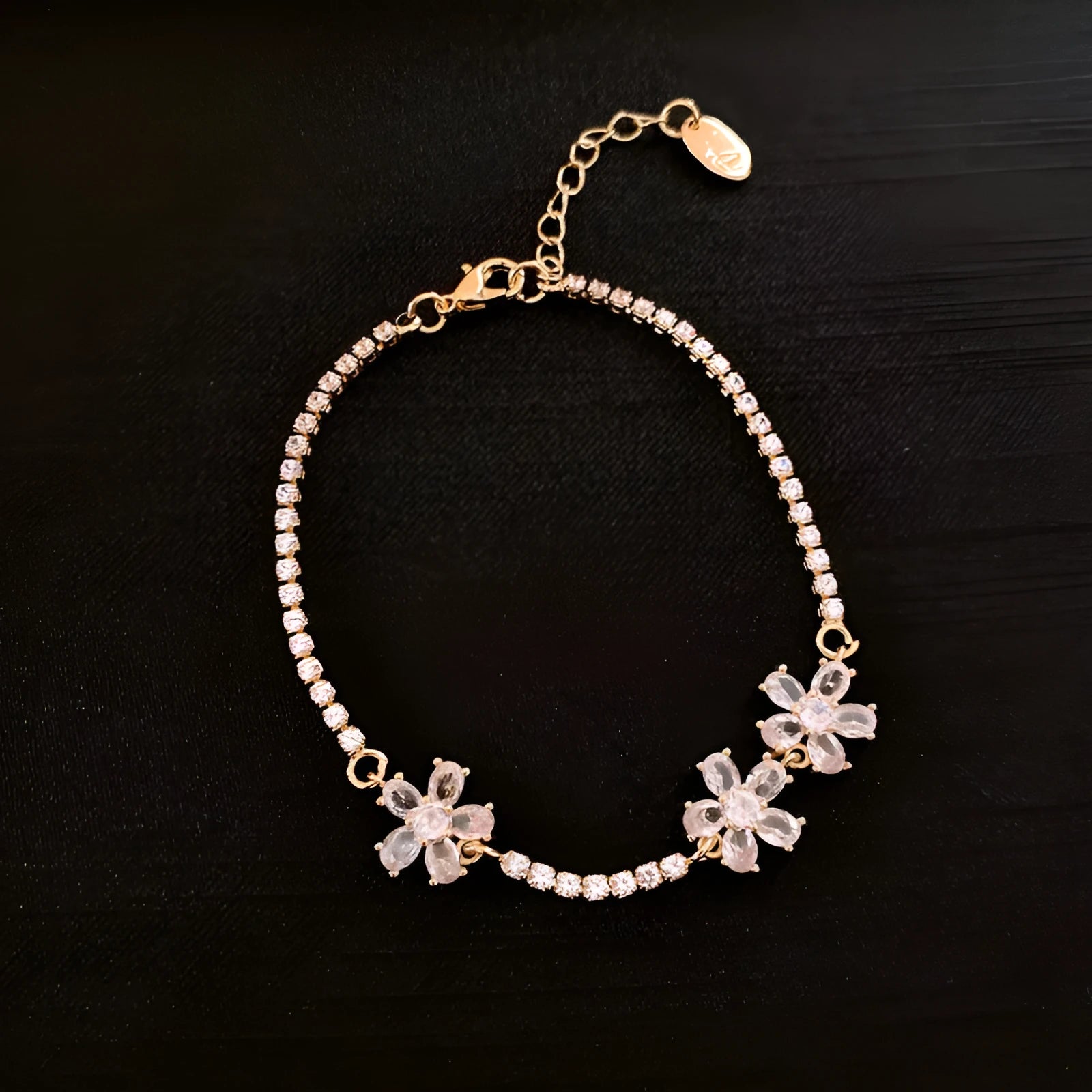 Gold-coloured women's bracelet with geometric quadrilateral design and zircon stone inlays