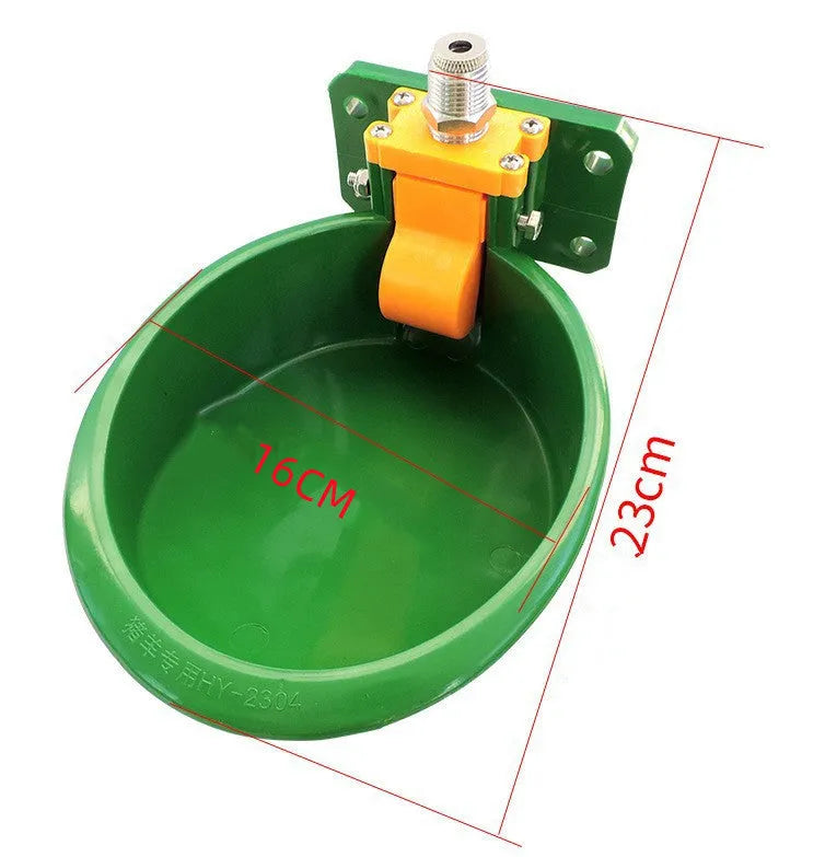 Green plastic livestock drinking bowl for sheep and pigs on farm