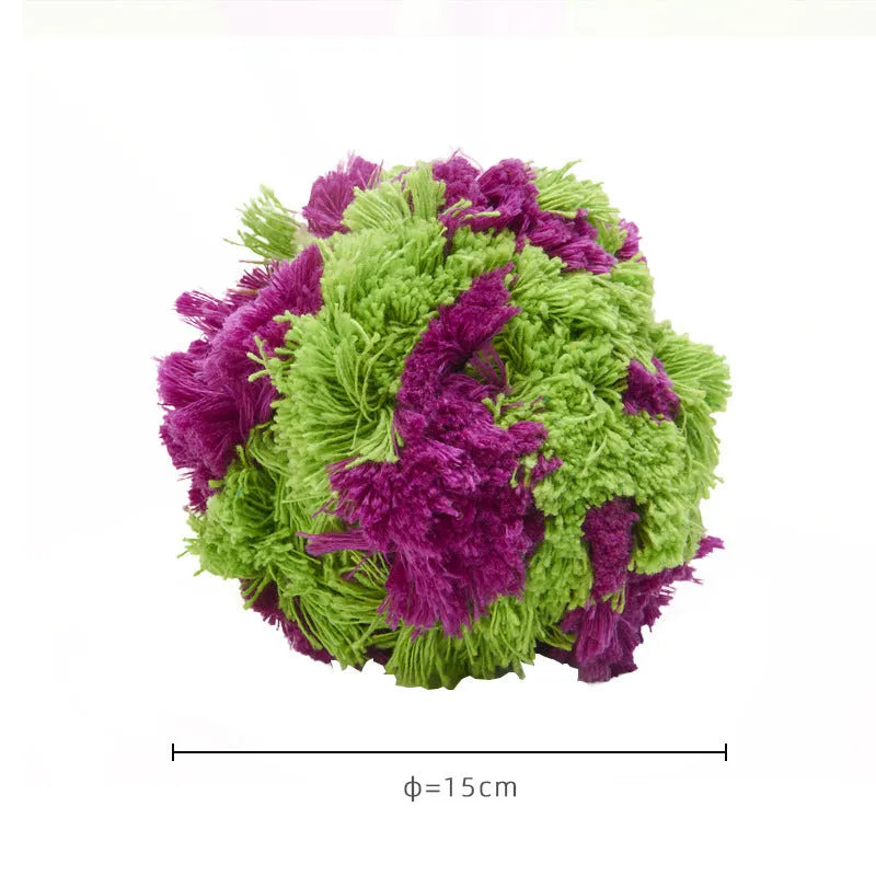 Purple plush knotty seaweed style dog chew toy ball for puppy teething and interactive fetch games.