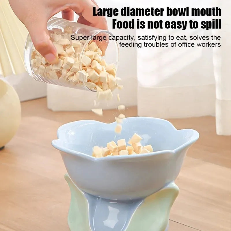 Blue ceramic raised pet bowl with floral pattern and non-slip base for cats and small dogs.