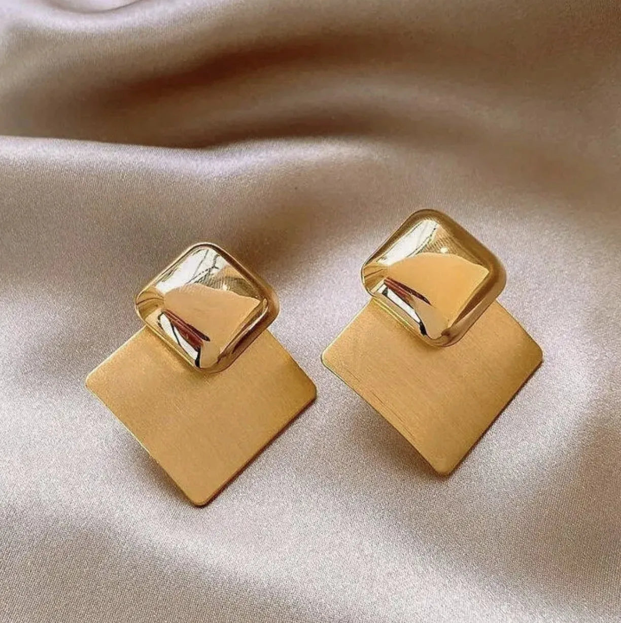 Women's gold brushed square stud earrings with 925 silver needle posts on a light background