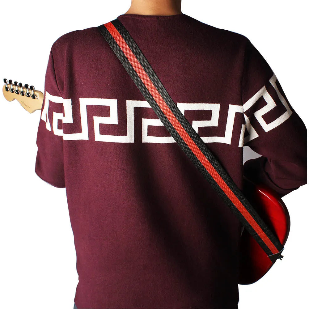 Woven striped crossbody guitar strap shown in multiple colours including army green, dark blue, red, white, and yellow.