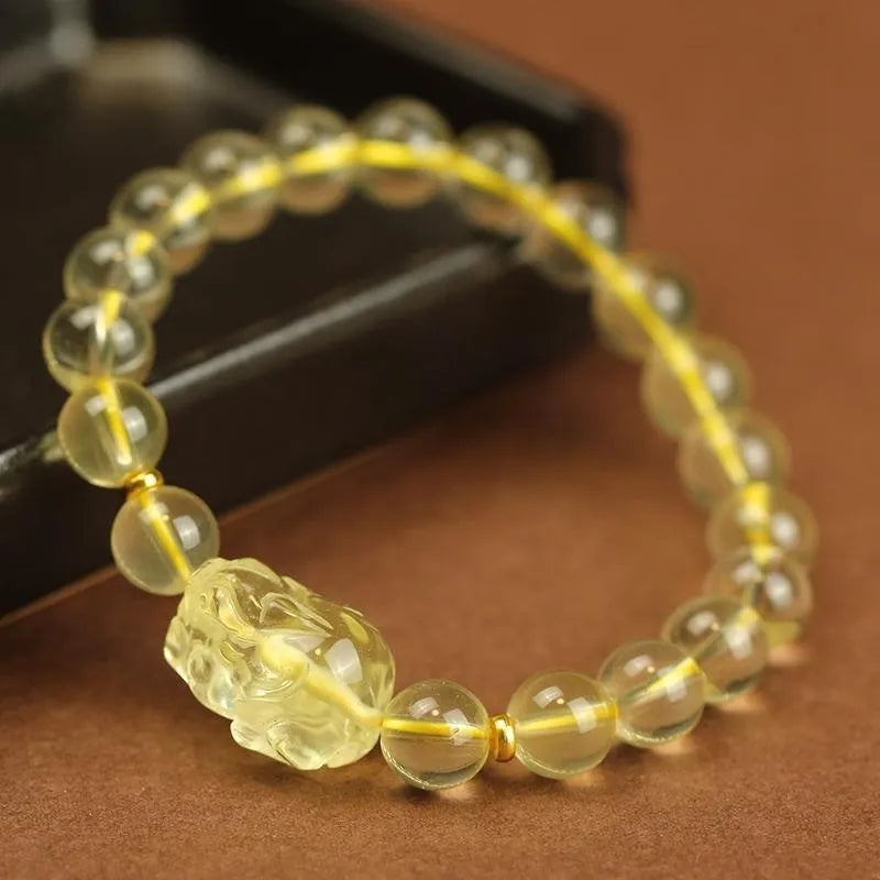 Yellow leather bracelet with artificial citrine crystals and a traditional Chinese Pi Xiu charm.