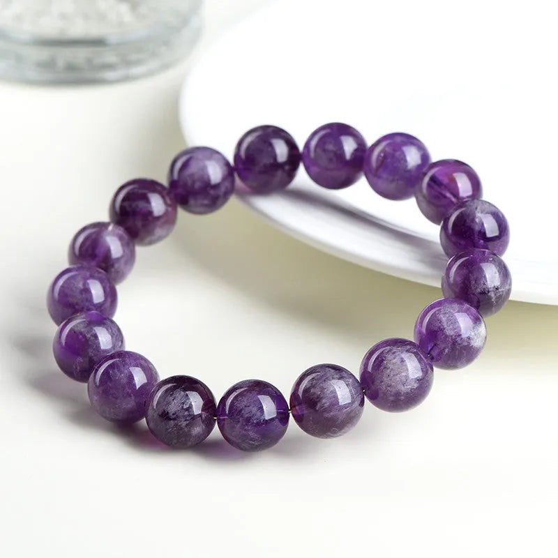 Natural feather amethyst crystal bracelet with scattered Snow Mountain purple beads and Ruyi detail.