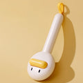 Small plastic pet comb with yellow duck design, showing open sections and floating needles for cat and dog grooming.