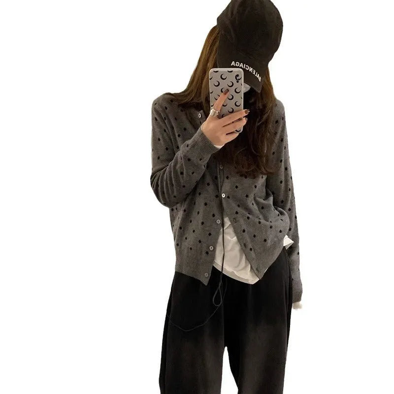 Women's grey dot pattern knitted cardigan with long sleeves and crocheted flower details