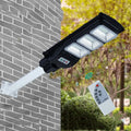 Integrated solar street light with LED panel and remote control for outdoor use.