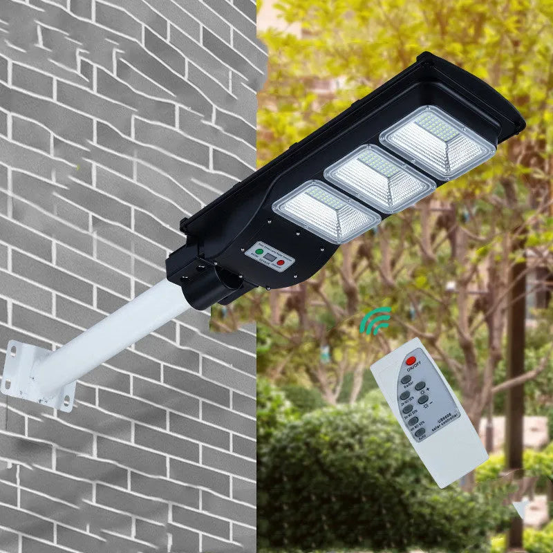 Integrated solar street light with LED panel and remote control for outdoor use.