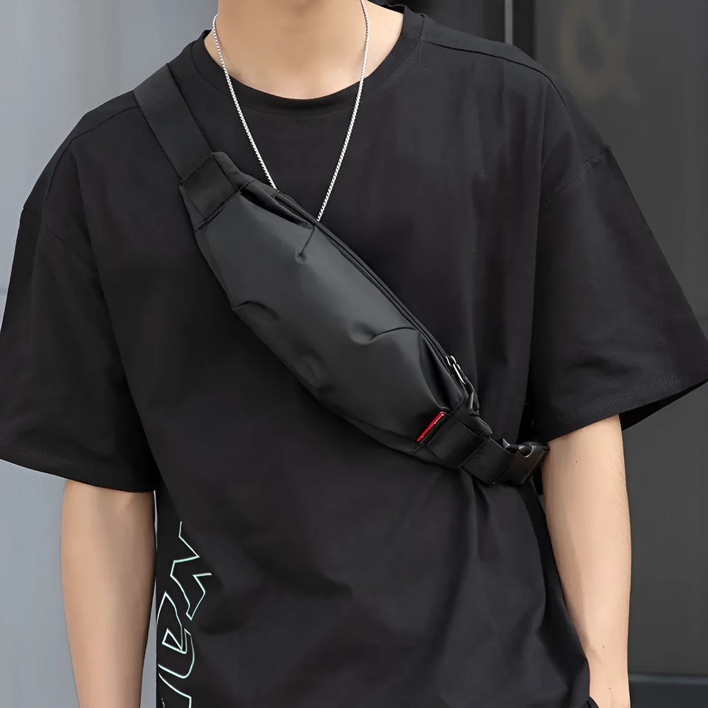 Black oxford cloth men's crossbody bag showing front zipper and internal phone and ID pockets.