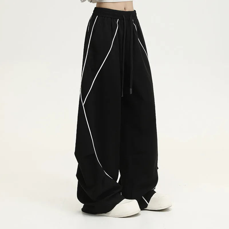 Black pleated hip hop trousers with wide-leg design and striped pattern