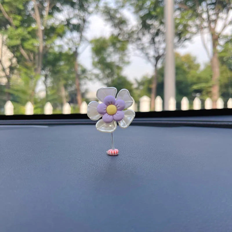 Colourful plastic swing car decoration measuring 5cm tall