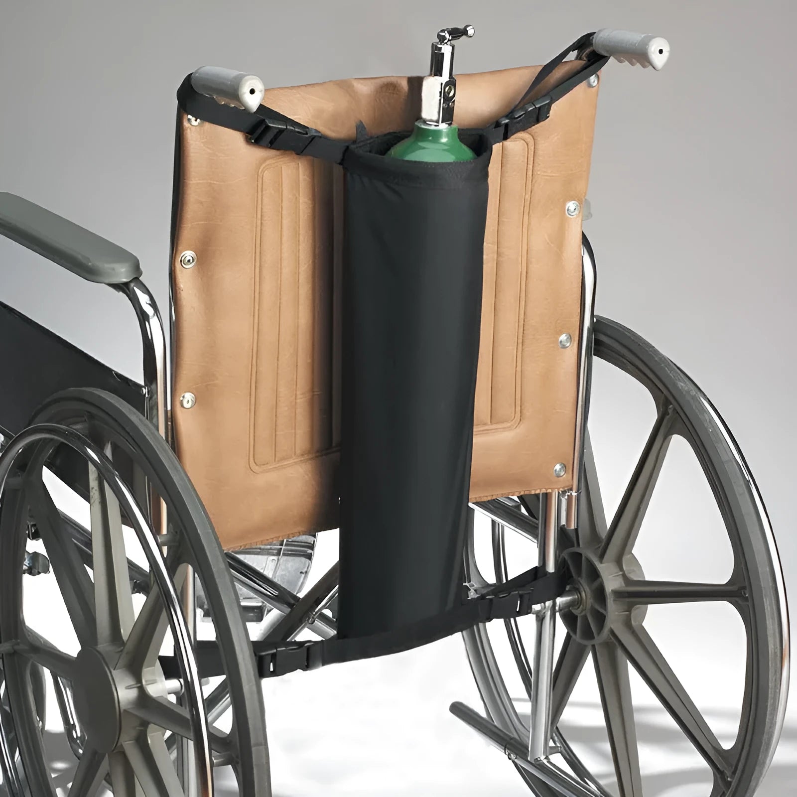 Black cylindrical outdoor pannier bag for carrying an oxygen cylinder on a wheelchair.
