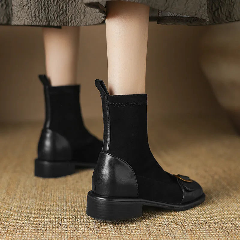 Women's black low-heel Martin ankle boots with buckle stitching and lace-up front.