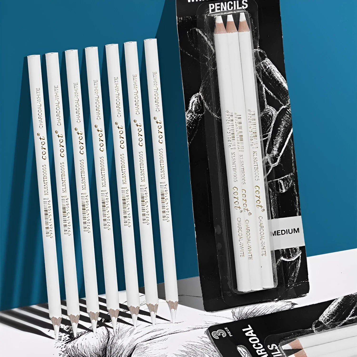 Three white charcoal pencils in wooden casings for art sketching on dark paper