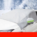 Magnetic anti frost car snow cover made from aluminium foil with magnets and reflective strips protecting a windscreen