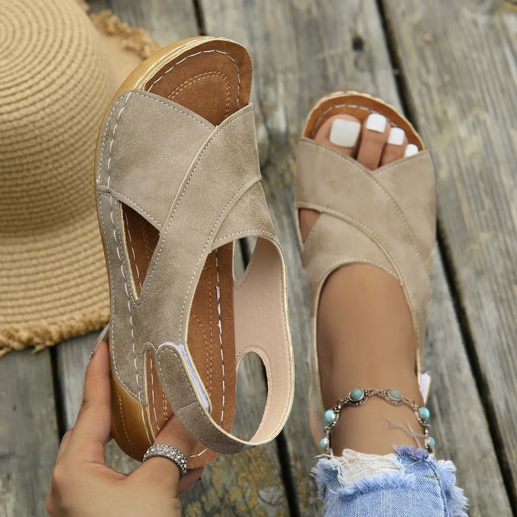 Women's brown Roman platform sandals with a skirt detail and Velcro strap.
