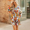 Orange floral print and striped lace V-neck long sleeve mini dress on a hanger.