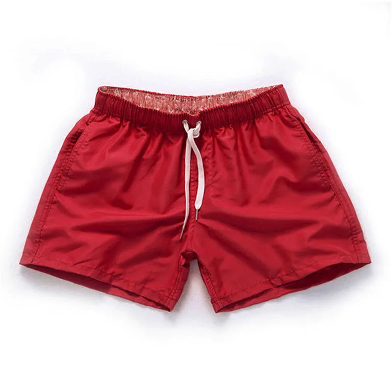 Men's black polyester beach shorts with a straight leg, shown on a size chart with options up to 4XL.
