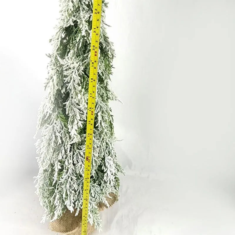 Small 24 inch white Christmas tree with built-in lights and simulated snow sprayer effect on branches