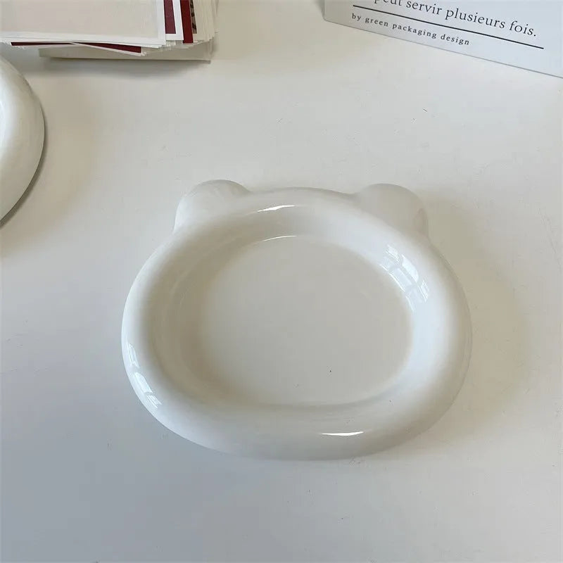 White ceramic plate with chubby bear or round toot design, shown in 15cm and 20cm sizes as a plant tray.