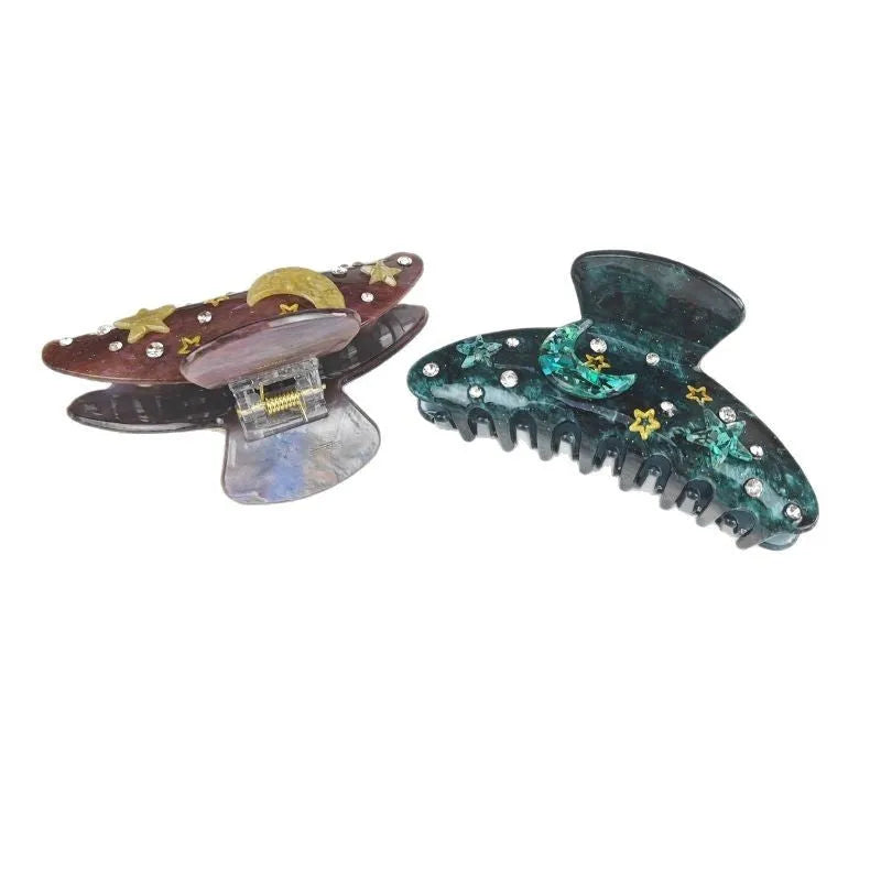 Oversized cellulose acetate hair barrette with star and moon pattern in starry sky design