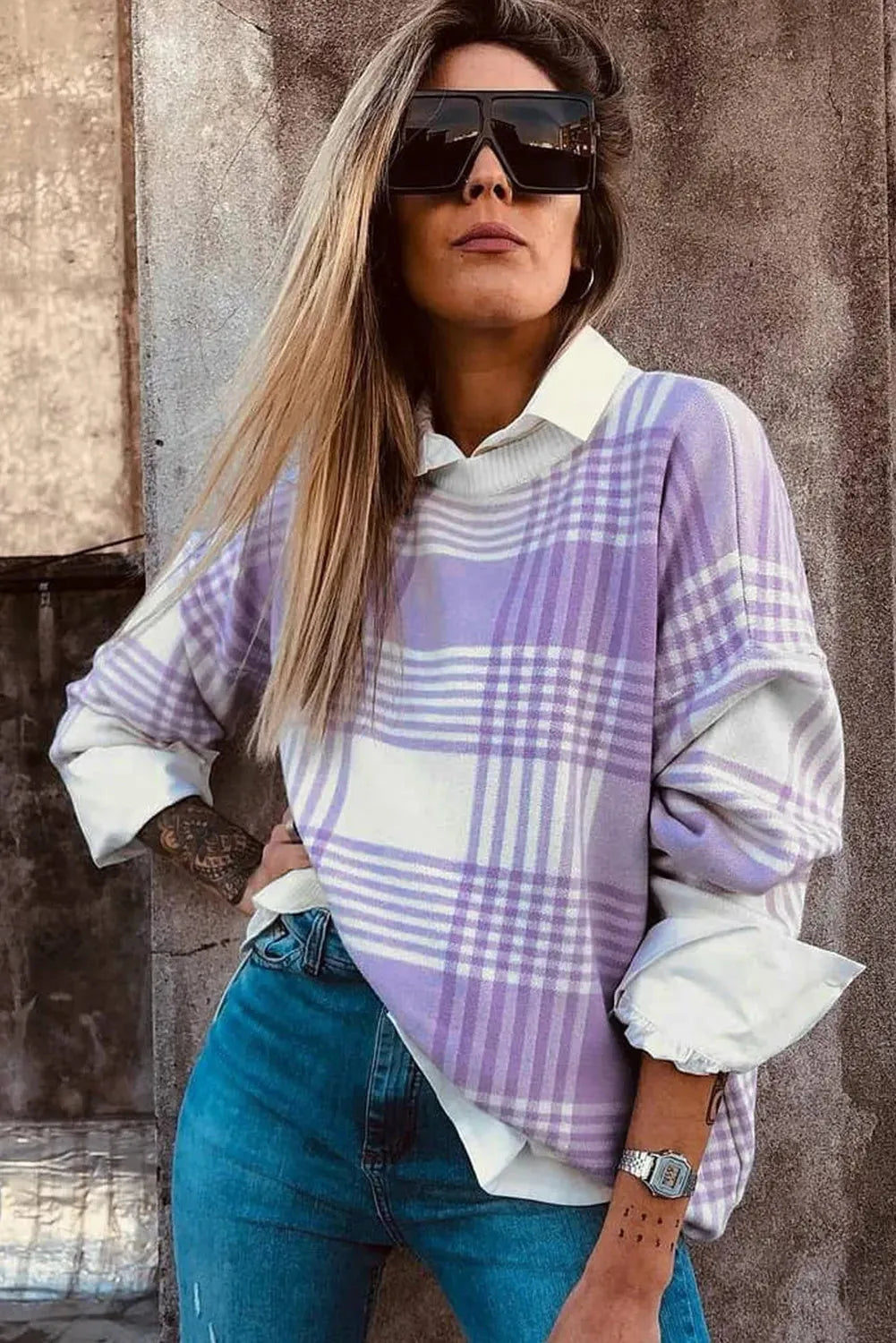Loose fit long sleeve sweater in lilac plaid print with ribbed cuffs and hem.