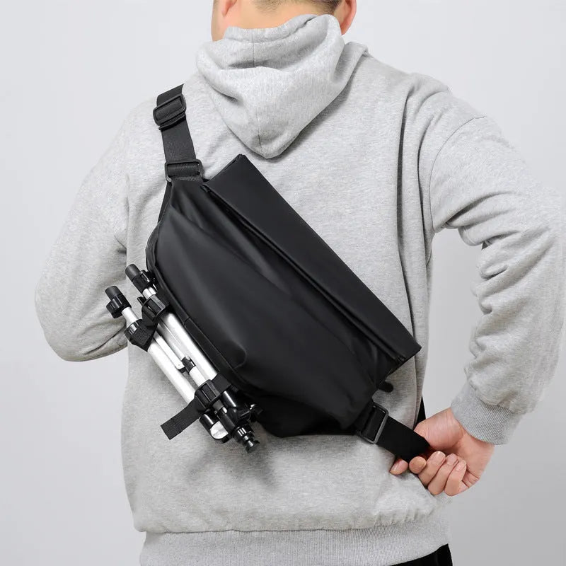 Grey men's crossbody sling backpack with zipper opening and shoulder strap