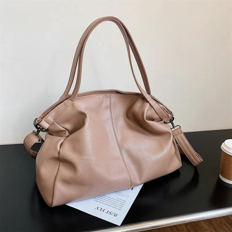 Large PU leather messenger bag with adjustable shoulder strap showing interior phone pocket organisation