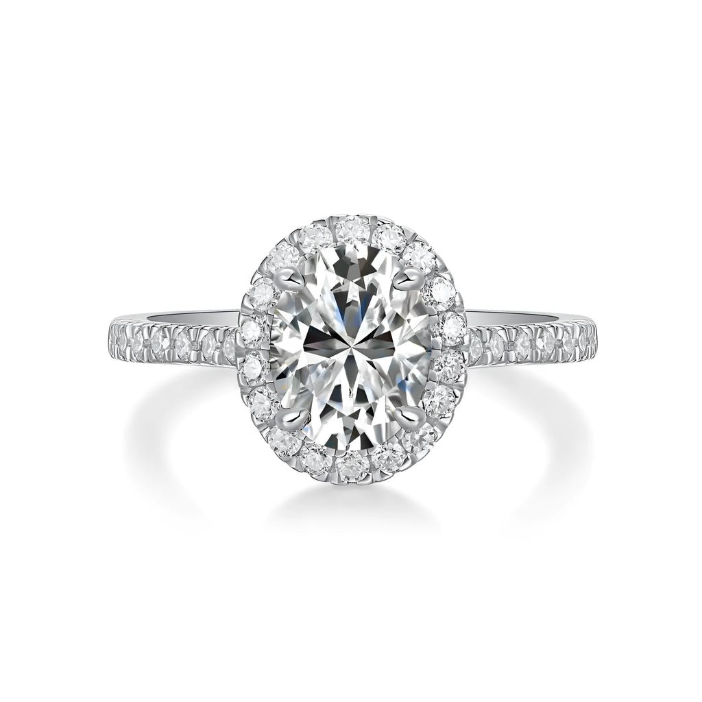 Egg-shaped 7x9mm moissanite wedding ring in S925 silver with platinum plating on white background