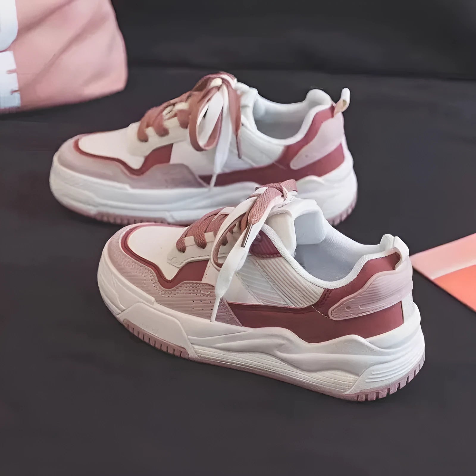 Beige and pink women's low top sneakers with a height increasing sole.