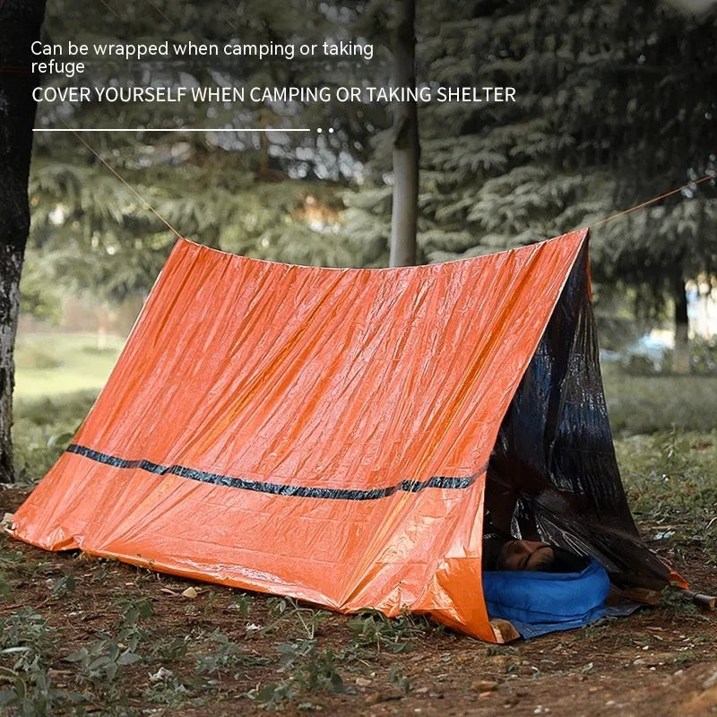 Portable orange disaster relief tent with sleeping bag and emergency blanket accessories