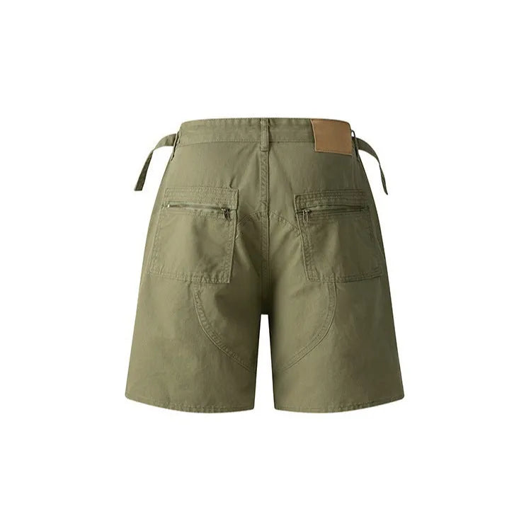 Retro loose-fit washed cotton workwear shorts for men and women on a hanger, showing zip fly and fifth-pants length.