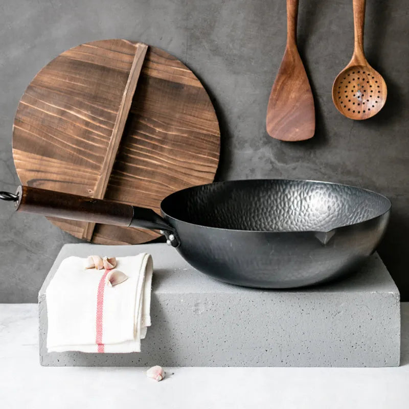 Traditional black iron wok with wooden handle measuring 32cm