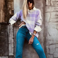 Loose fit long sleeve sweater in lilac plaid print with ribbed cuffs and hem.