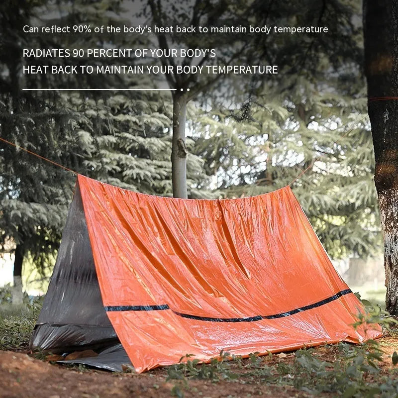 Portable orange disaster relief tent with sleeping bag and emergency blanket accessories