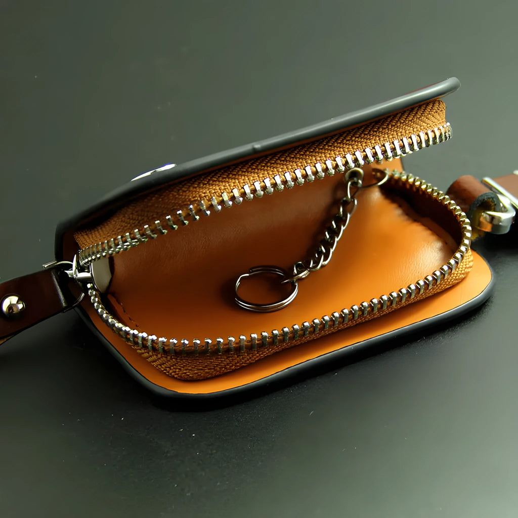 Black genuine leather car key case with a silver V-shaped zipper closed.