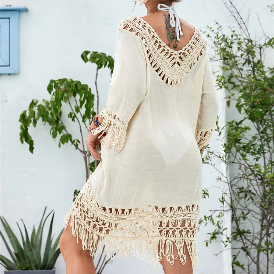 Apricot crocheted patchwork beach dress with half sleeves and mid-length skirt on hanger