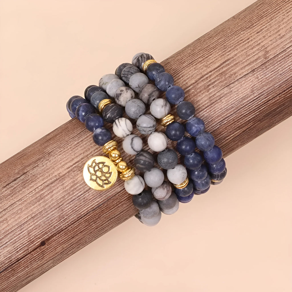 Close-up of a blue multi-layer bracelet with patterned network stone beads and a silver alloy chain.
