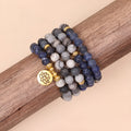 Close-up of a blue multi-layer bracelet with patterned network stone beads and a silver alloy chain.