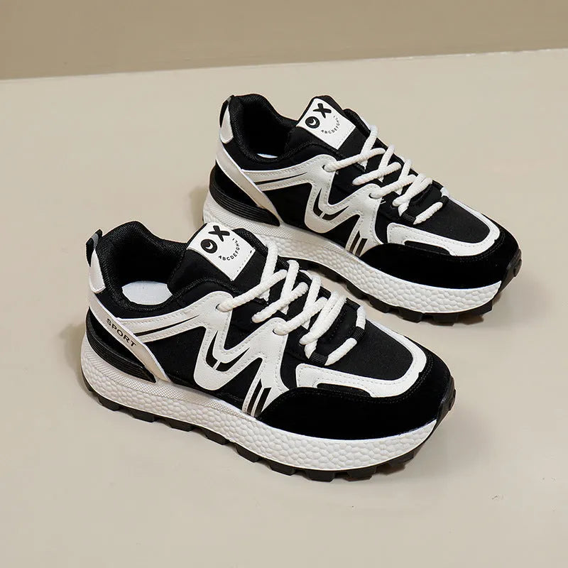Women's flat-heel casual sports shoes in black with round toe and front lace-up design.