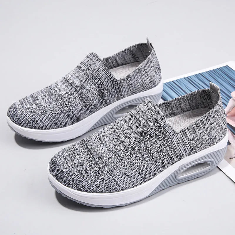 Women's beige artificial PU mesh running shoes with air cushion and round toe on a plain background.