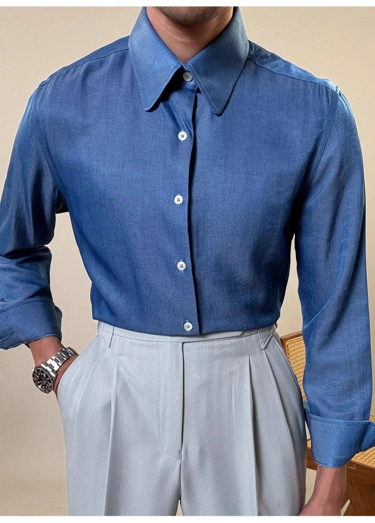 Man wearing a slim-fit light blue round collar long sleeve shirt for business casual wear.