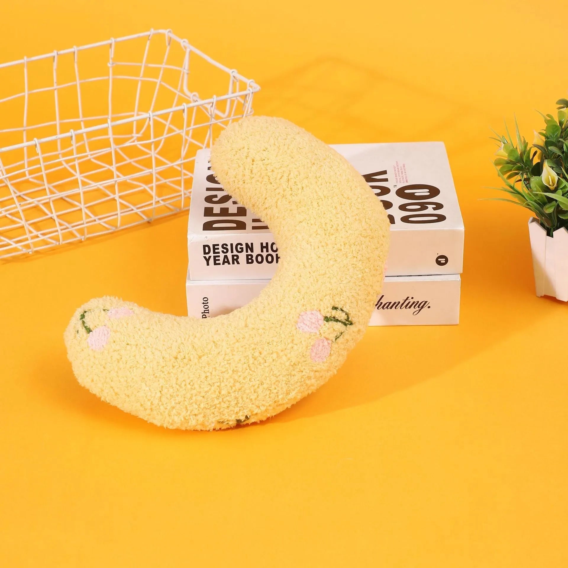 Half moon U-shaped cloth pillow for cats in blue, pink, white, and yellow colour options.