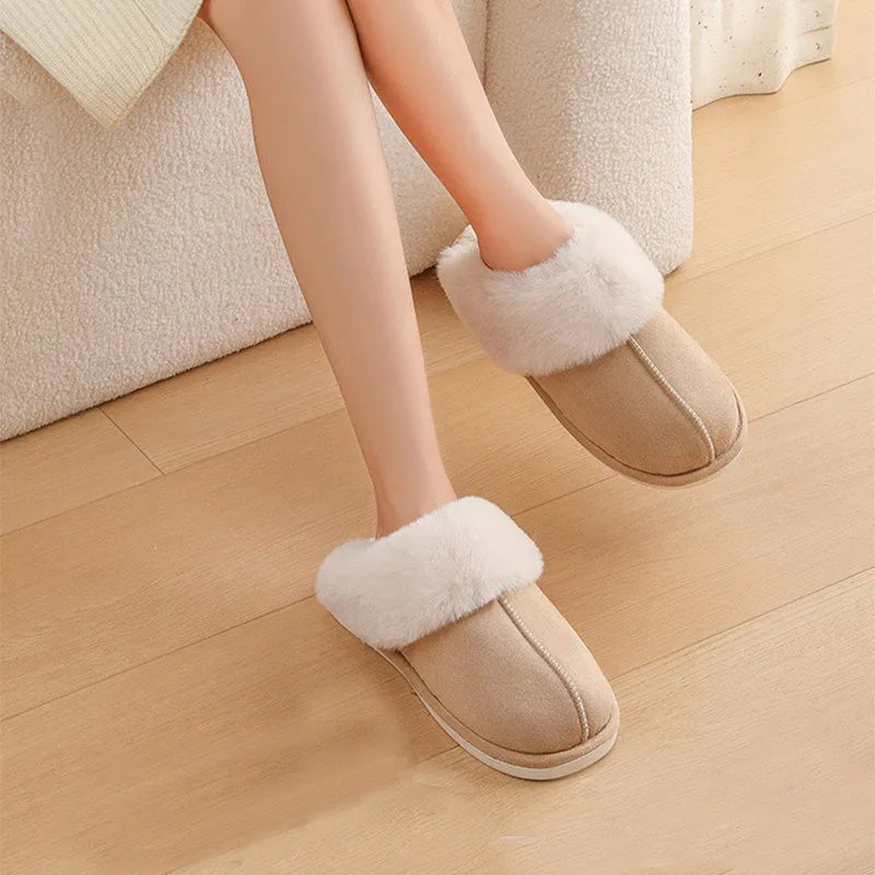 A pair of brown plush winter slippers with a round toe, flat heel, and non-slip PVC sole.
