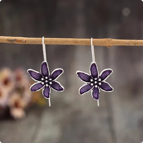 Pair of purple retro-style flower-shaped alloy earrings for women.