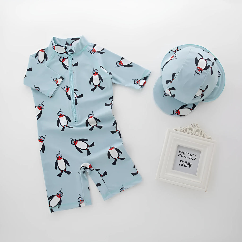 Boys' penguin print polyester swimsuit set with matching swimming cap for sun protection