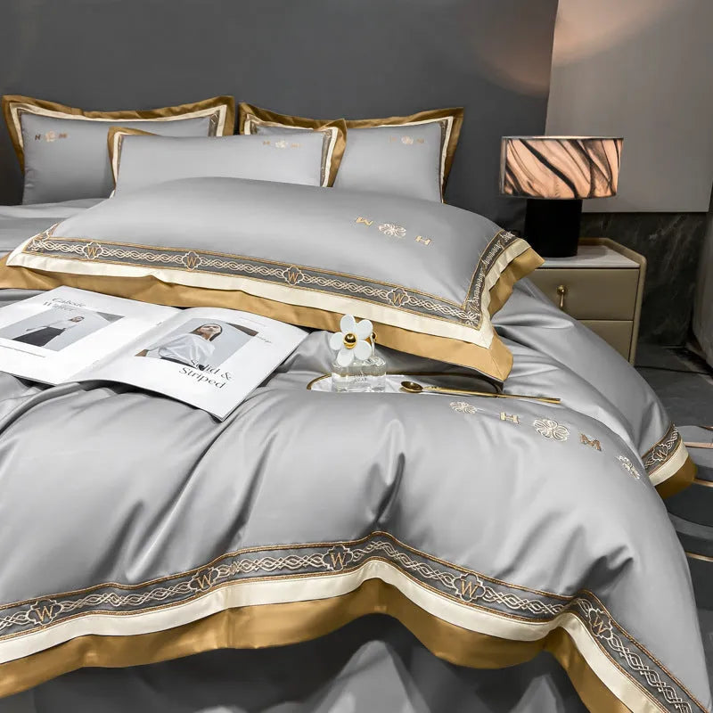 All-cotton light luxury four-piece bedding set with embroidery, available in multiple colours, on a bed